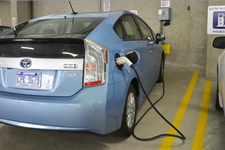 EV auto plugged into garage wall